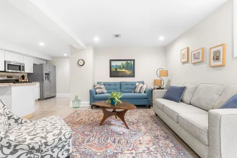 a living room with furniture and kitchen view