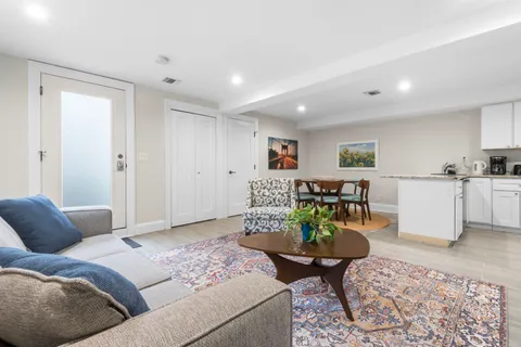 a living room with furniture and wooden floor