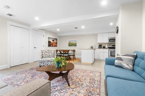 a living room with furniture and kitchen view