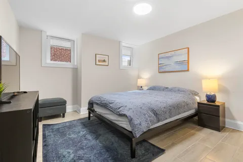 a bedroom with a bed and a desk