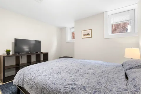 a bedroom with a bed and a flat screen tv