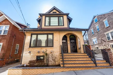 a view of a brick house with large windows