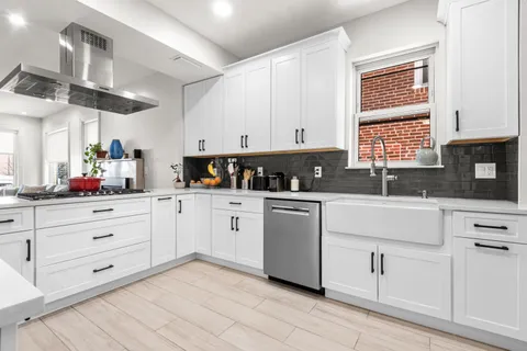 a kitchen with cabinets appliances and a window