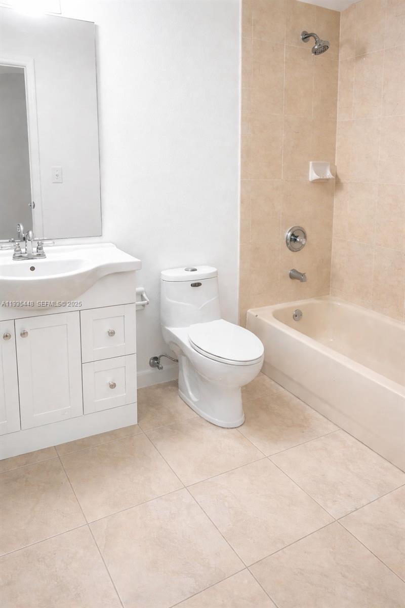 14964 Southwest 32nd Terrace Miami, FL 33185 - Photo 8 of 10 a bathroom with a double vanity sink a toilet and bathtub