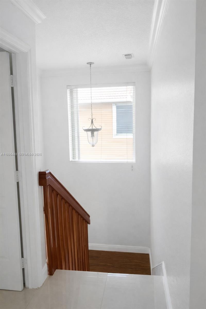 14964 Southwest 32nd Terrace Miami, FL 33185 - Photo 9 of 10 an empty room with wooden floor and windows