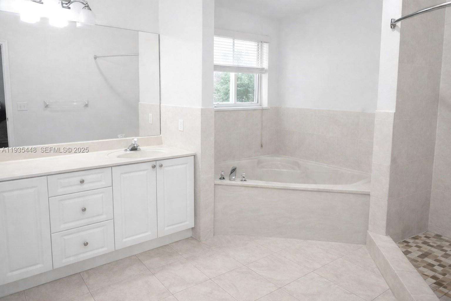 14964 Southwest 32nd Terrace Miami, FL 33185 - Photo 10 of 10 a bathroom with a bathtub sink and mirror