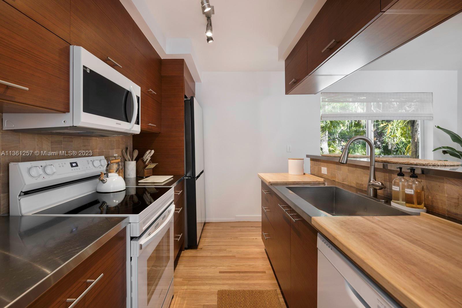 3894 Main Highway Coconut Grove, FL 33133 - Photo 11 of 28 a kitchen that has a sink and a stove
