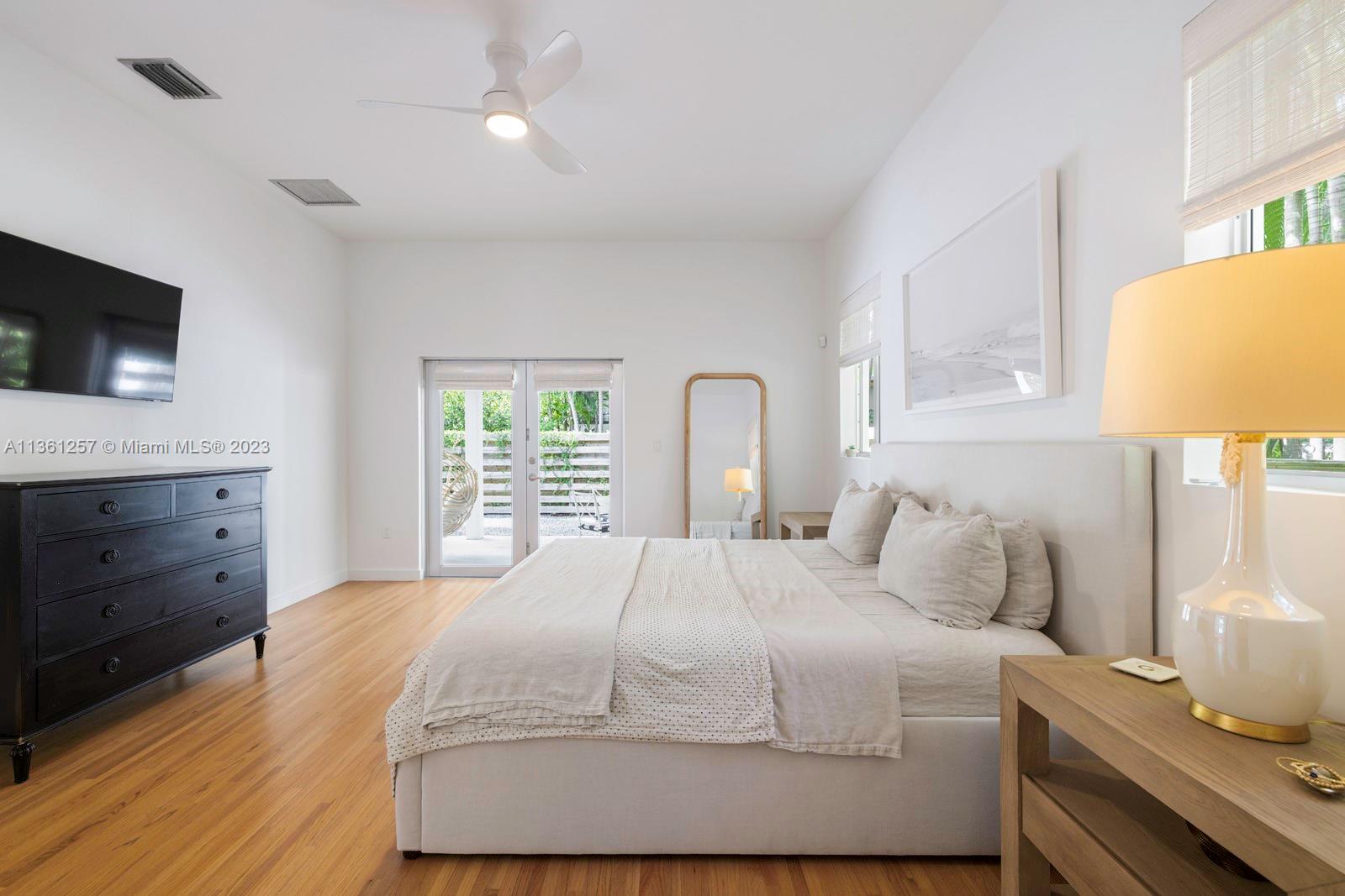 3894 Main Highway Coconut Grove, FL 33133 - Photo 13 of 28 a bedroom with a bed and a flat screen tv