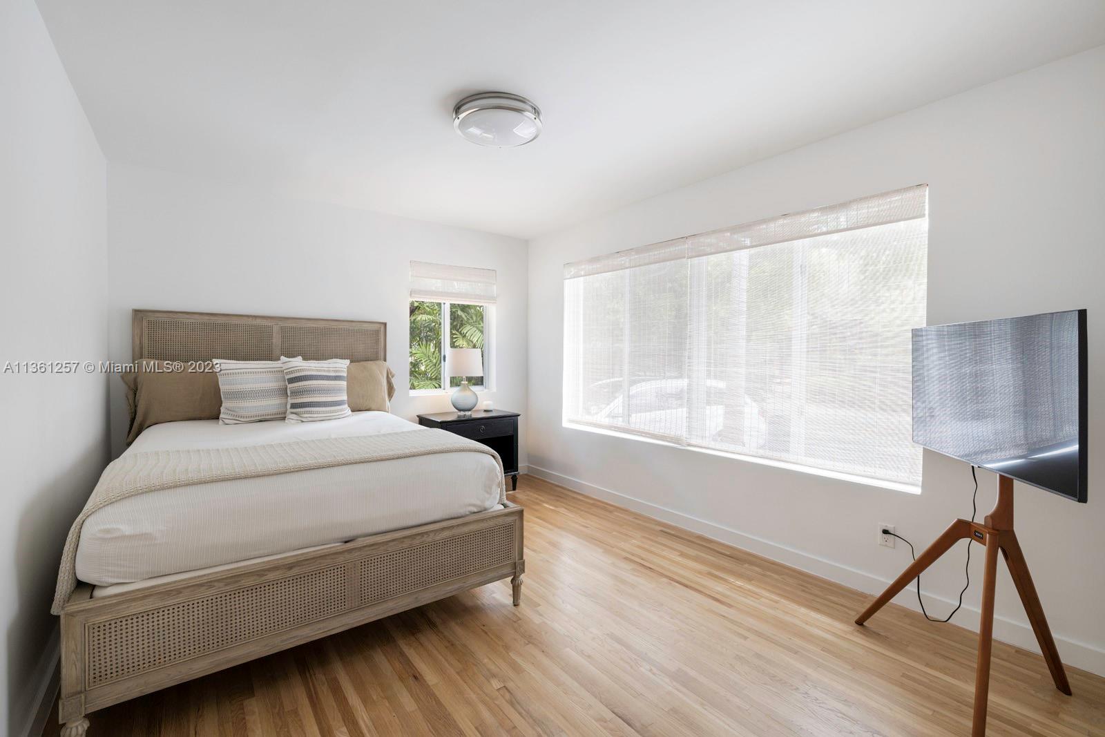 3894 Main Highway Coconut Grove, FL 33133 - Photo 16 of 28 a large bed sitting in a bedroom next to a window