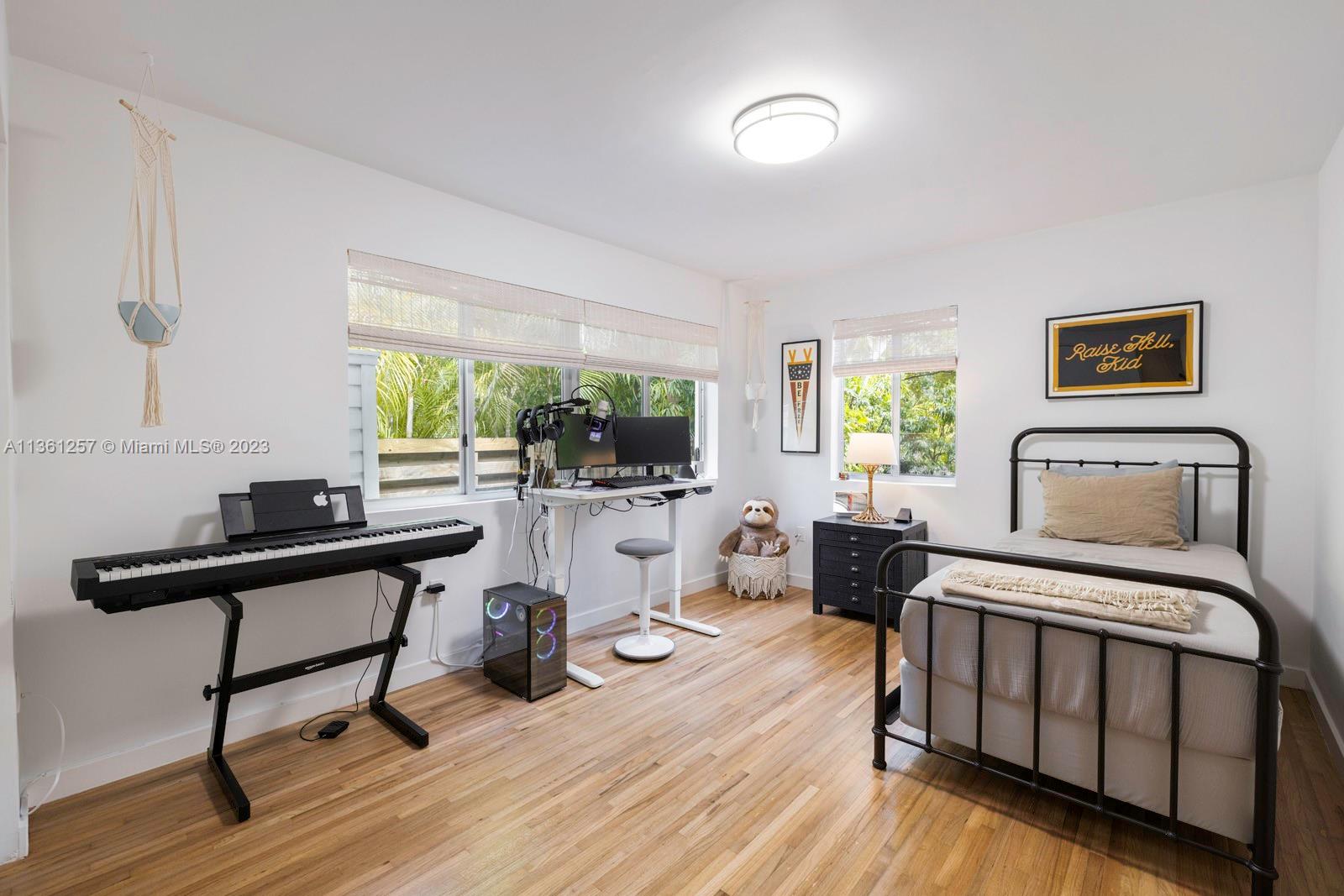 3894 Main Highway Coconut Grove, FL 33133 - Photo 17 of 28 a bedroom with furniture and a wooden floor