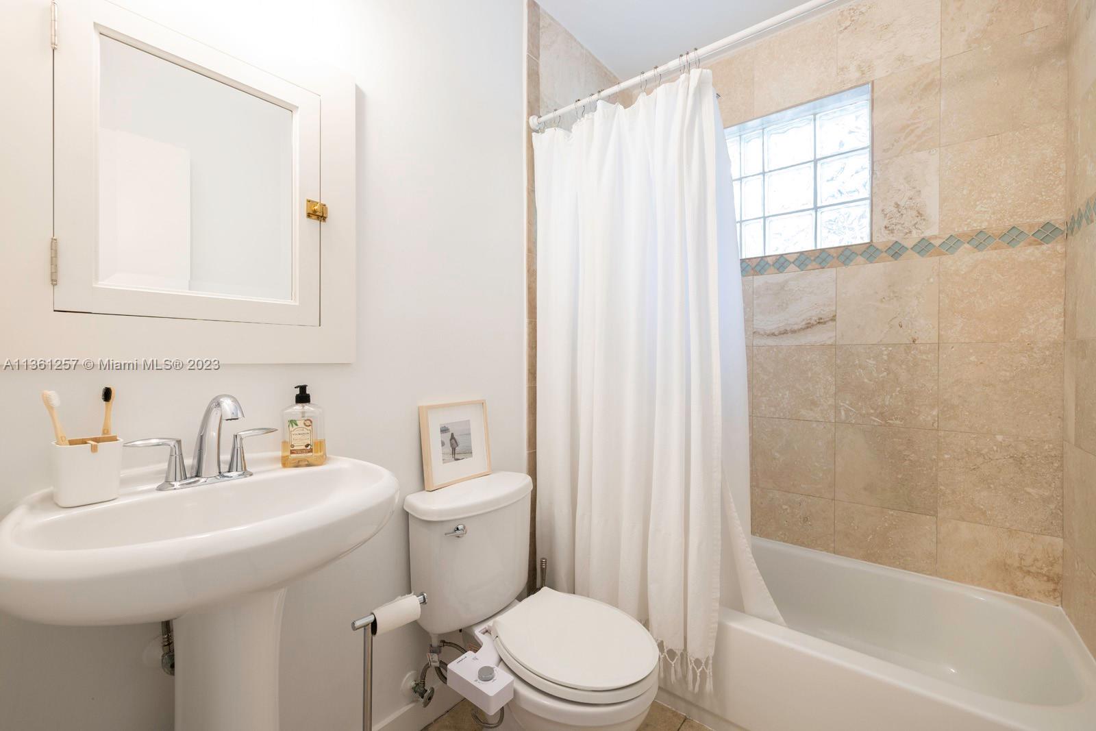 3894 Main Highway Coconut Grove, FL 33133 - Photo 18 of 28 a bathroom with a sink toilet and shower