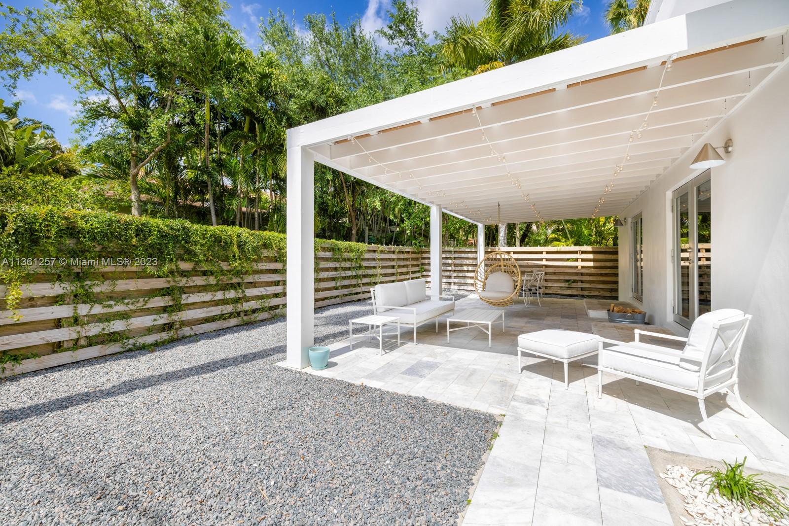 3894 Main Highway Coconut Grove, FL 33133 - Photo 22 of 28 a view of a patio with table and chairs and wooden fence