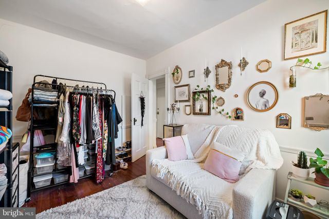 a living room with furniture a clock and a bookshelf
