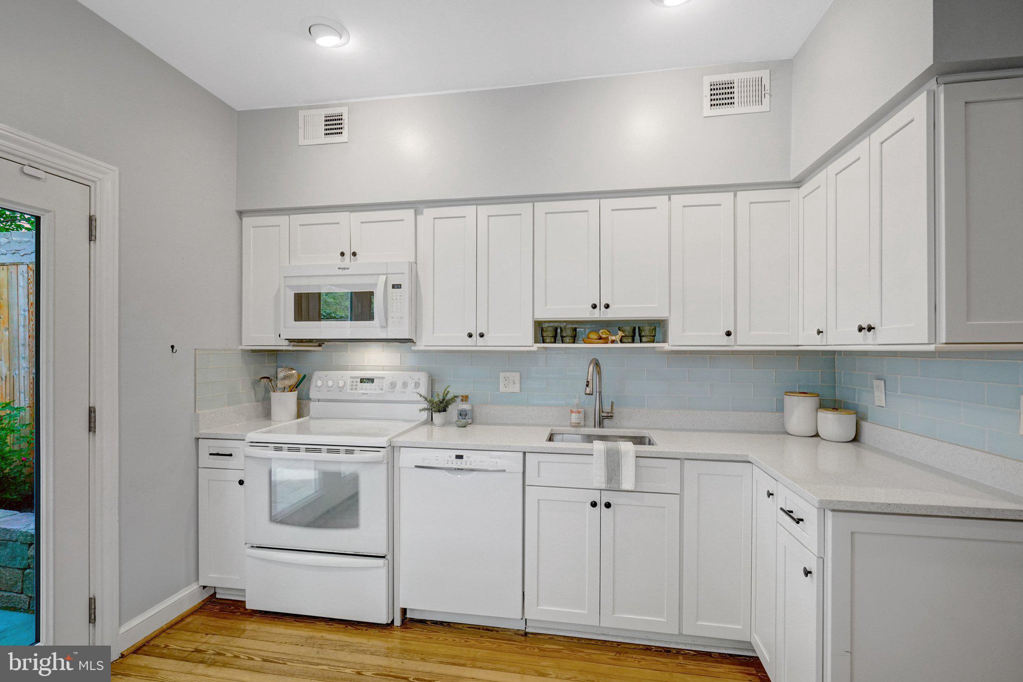 707 10th Street Southeast Washington, DC 20003 - Photo 16 of 46 Copious cabinets, quartz counters, subway tile