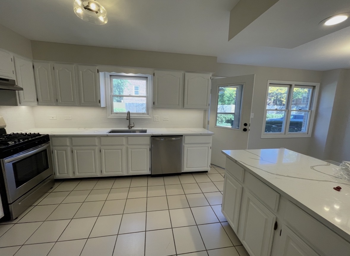 1703 Winnetka Road Northfield, IL 60093 - Photo 4 of 10 a kitchen with a sink a stove cabinets and counter space