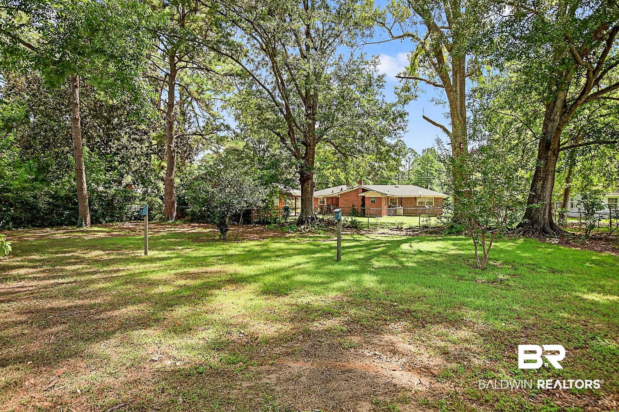 101 Terry Avenue Brewton, AL 36426 - Photo 16 of 48 View of yard with view of wooded area