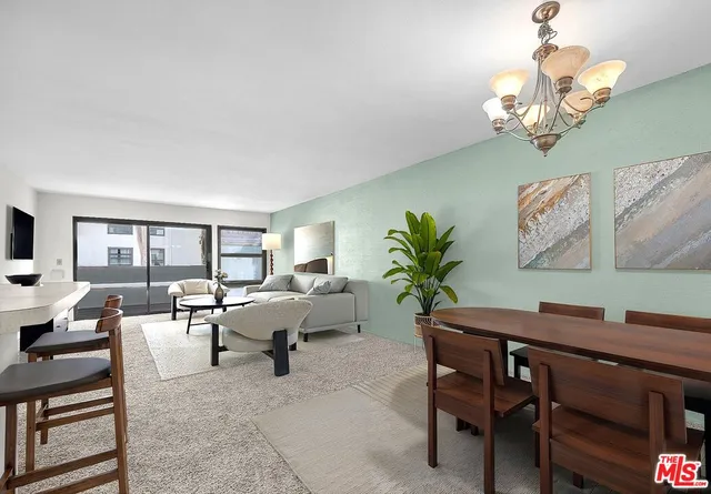 a living room with furniture a chandelier and a window