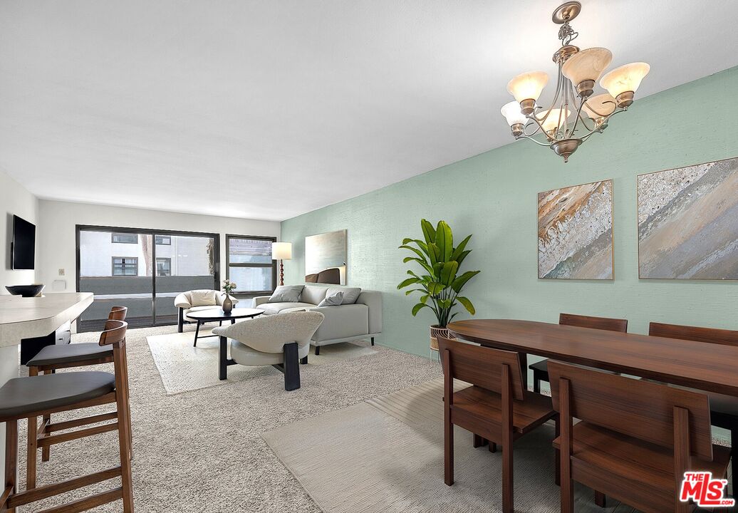 a living room with furniture a chandelier and a window