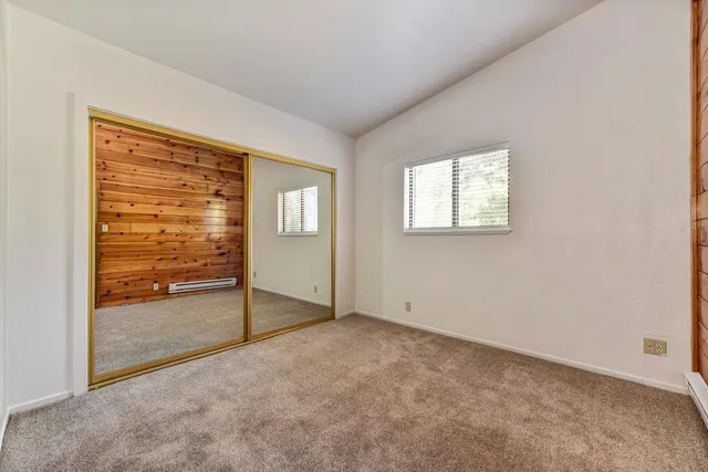 a bath tub sitting next to a white sink and a window