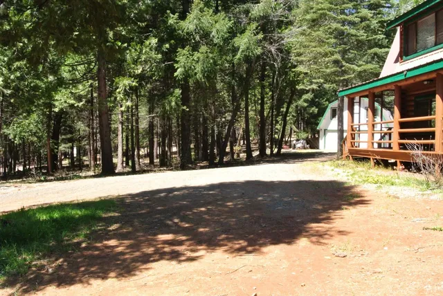 a view of a house with a yard and garage