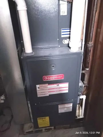 a view of a brick house with a bench in front of door