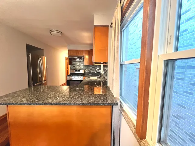 a kitchen with granite countertop a sink and a counter top space