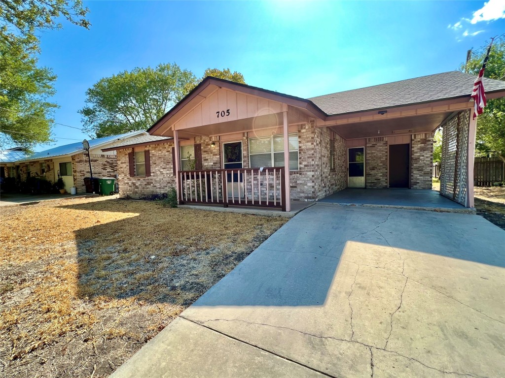 705 Guadalimar Street Lockhart, TX 78644 - Photo 1 of 1 a front view of a house with garden
