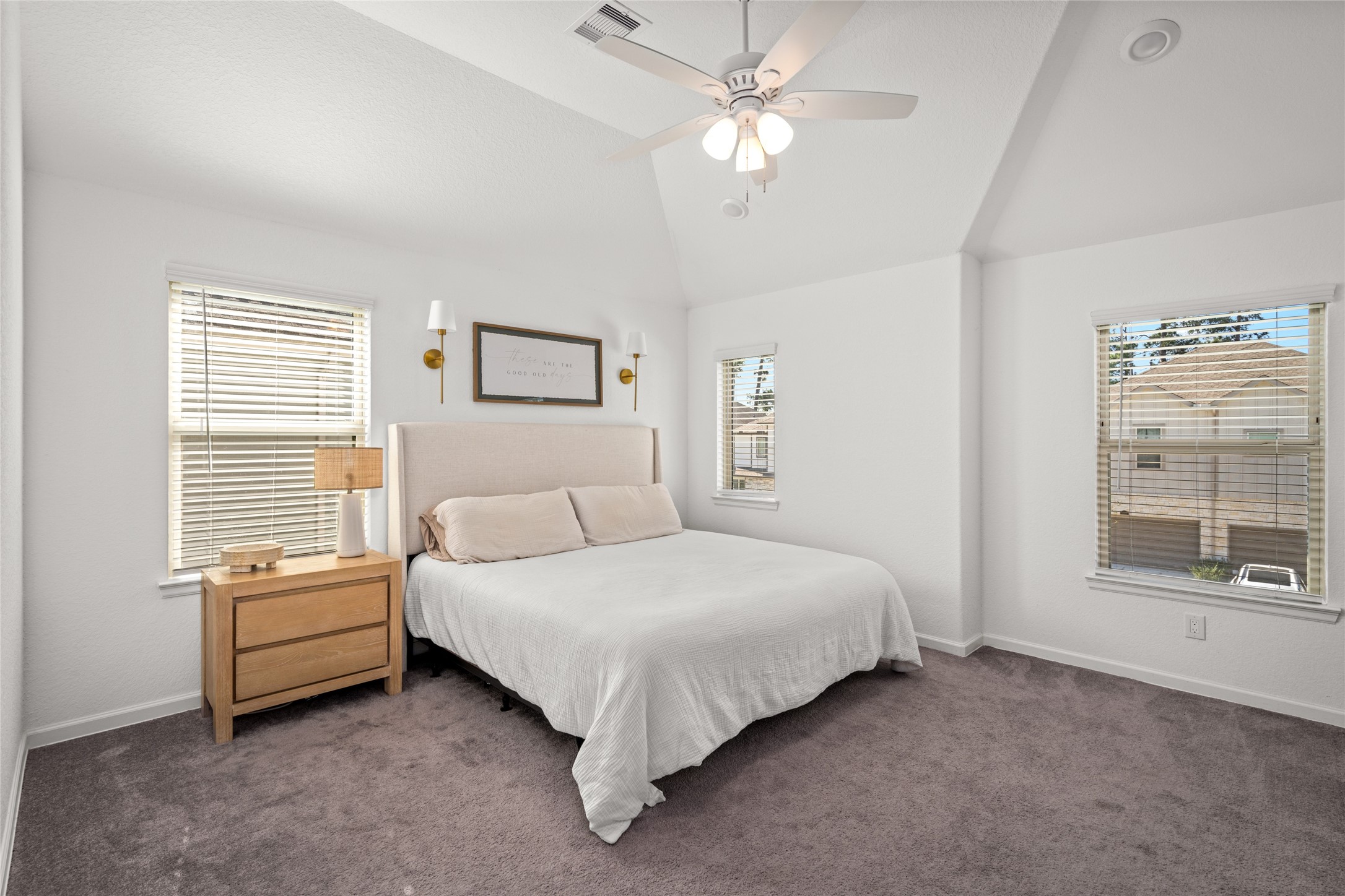 575 Dry Fork Lane Conroe, TX 77304 - Photo 16 of 34 Spacious upstairs bedroom featuring vaulted ceilings, multiple windows for natural light, and neutral finishes.