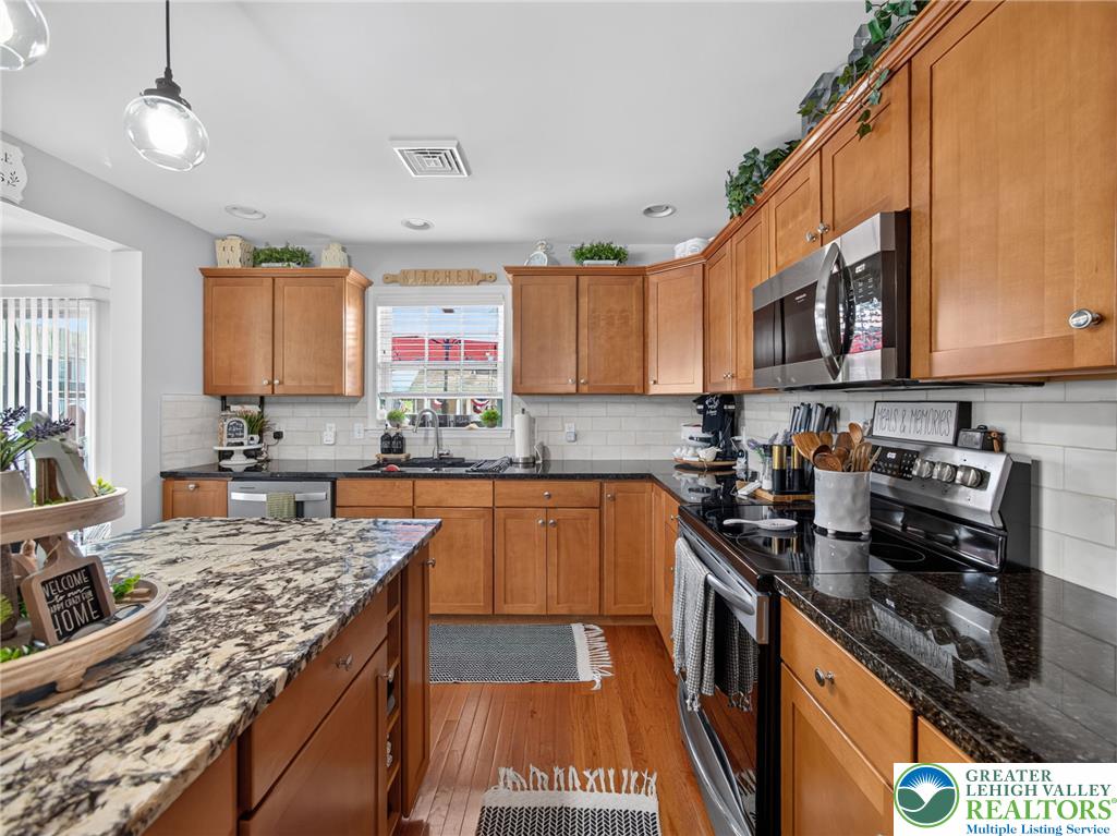 4148 Ross Road Bethlehem, PA 18020 - Photo 33 of 67 A well-appointed kitchen features rich wood cabinetry and ample counter space for culinary endeavors.
