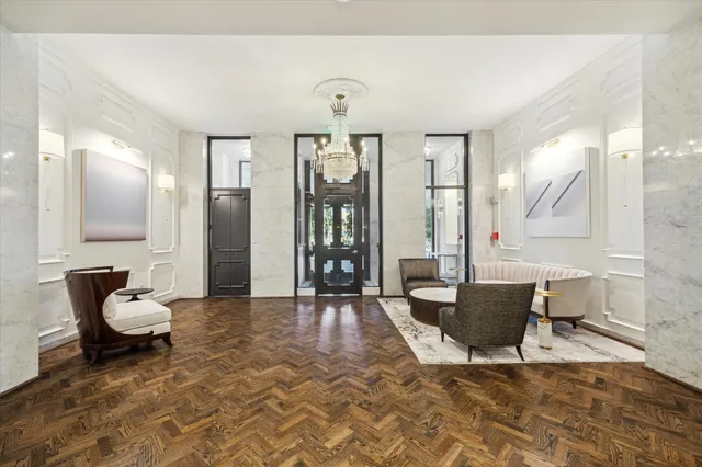 a living room with furniture a window and a chandelier