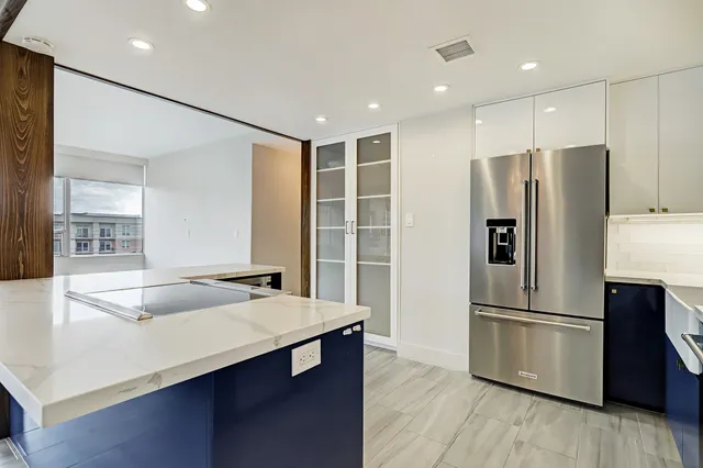 a kitchen with stainless steel appliances a refrigerator and a sink