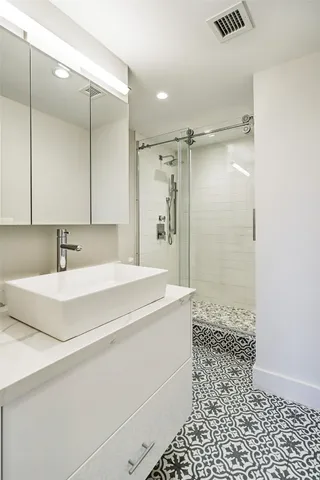 a spacious bathroom with a shower and a sink