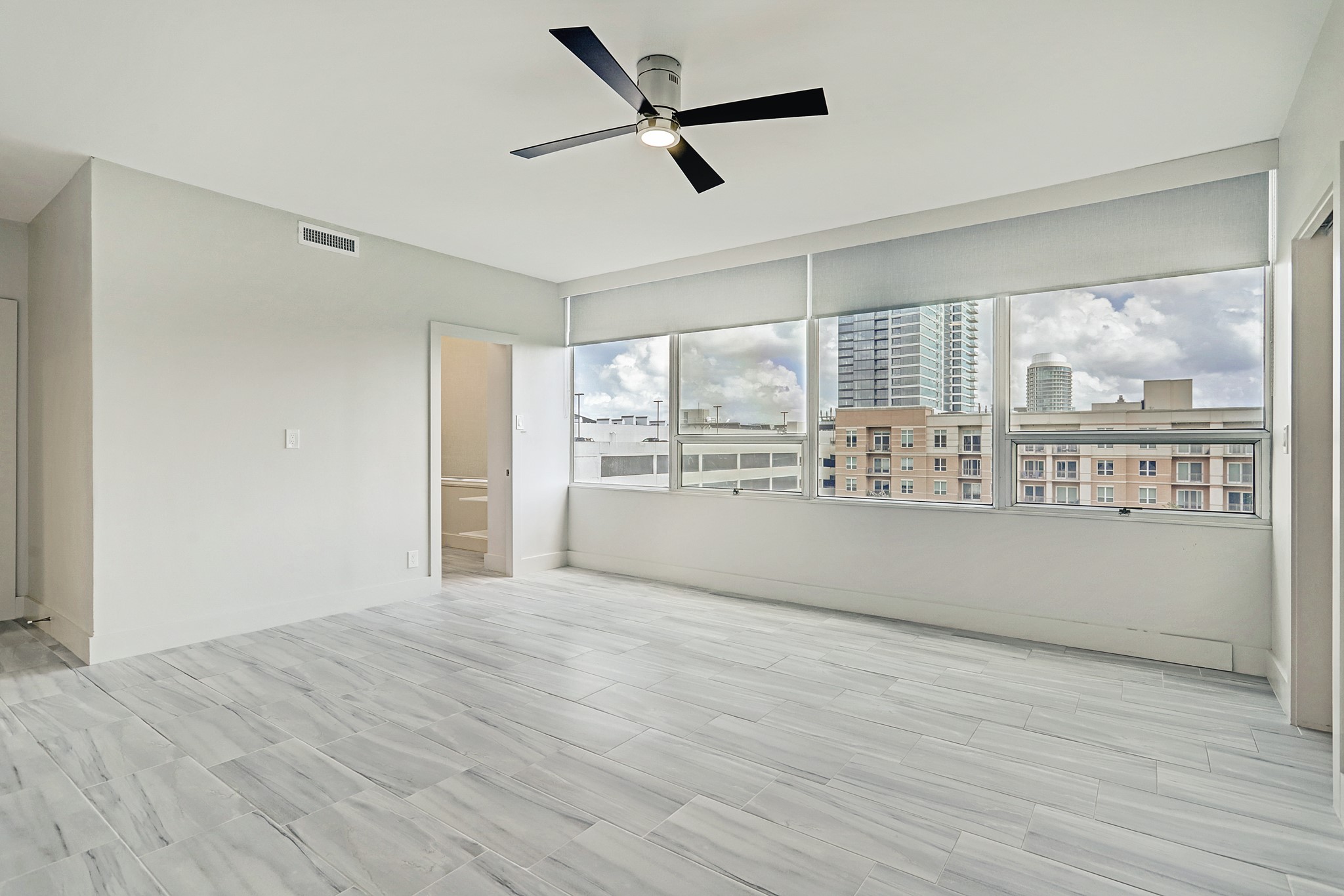 2701 Westheimer Road, Unit 8B Houston, TX 77098 - Photo 10 of 28 a view of empty room with wooden floor and fan