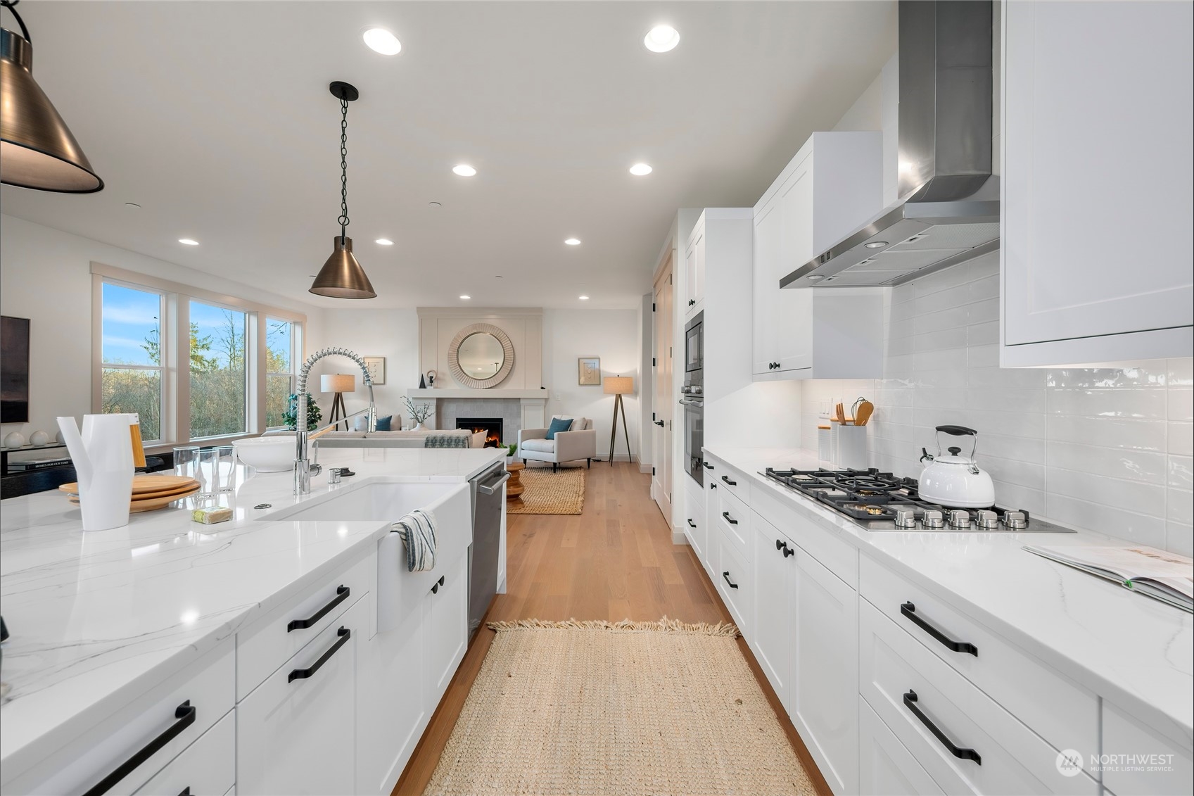 324 174th Street Southeast Bothell, WA 98012 - Photo 11 of 37 a large kitchen with stainless steel appliances kitchen island granite countertop a lot of counter space and a sink