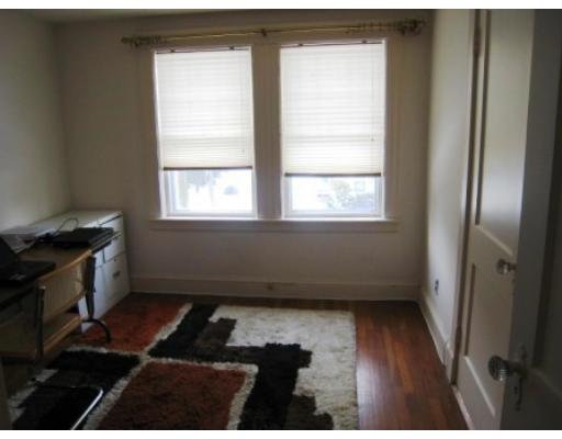 30 Spring Street Lexington, MA 02421 - Photo 15 of 18 a room with wooden floor and a window