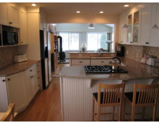 30 Spring Street Lexington, MA 02421 - Photo 6 of 18 a kitchen with a stove a refrigerator and a microwave