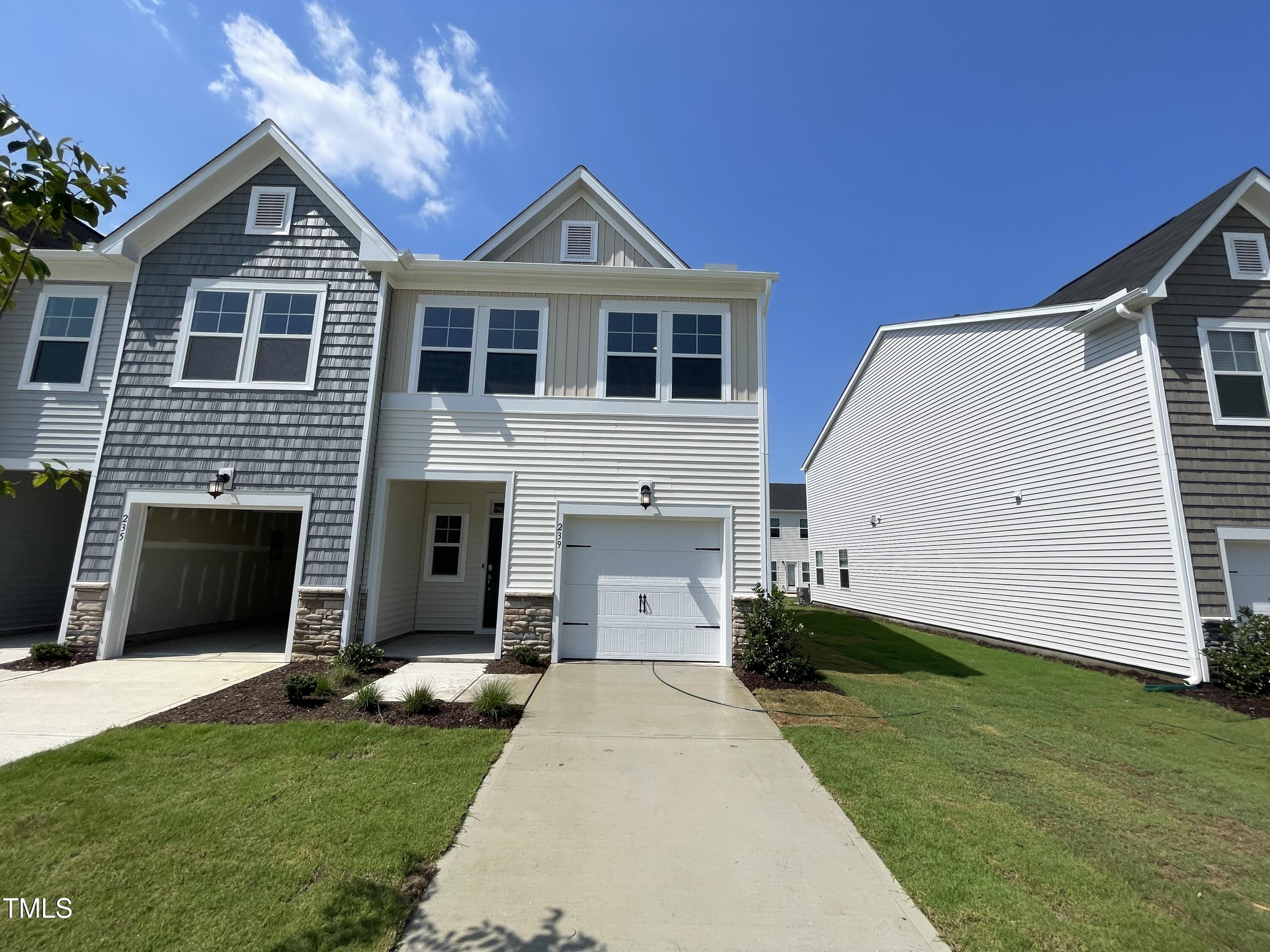 239 Paramount Drive Smithfield, NC 27577 - Photo 1 of 16 a front view of a house with a yard and garage