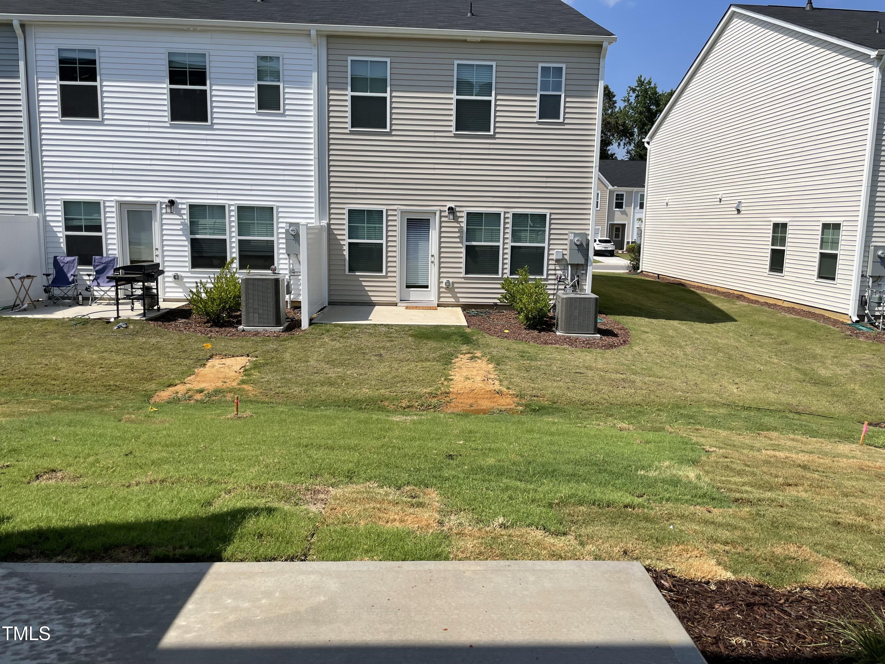 239 Paramount Drive Smithfield, NC 27577 - Photo 16 of 16 a view of a patio with table and chairs and potted plants
