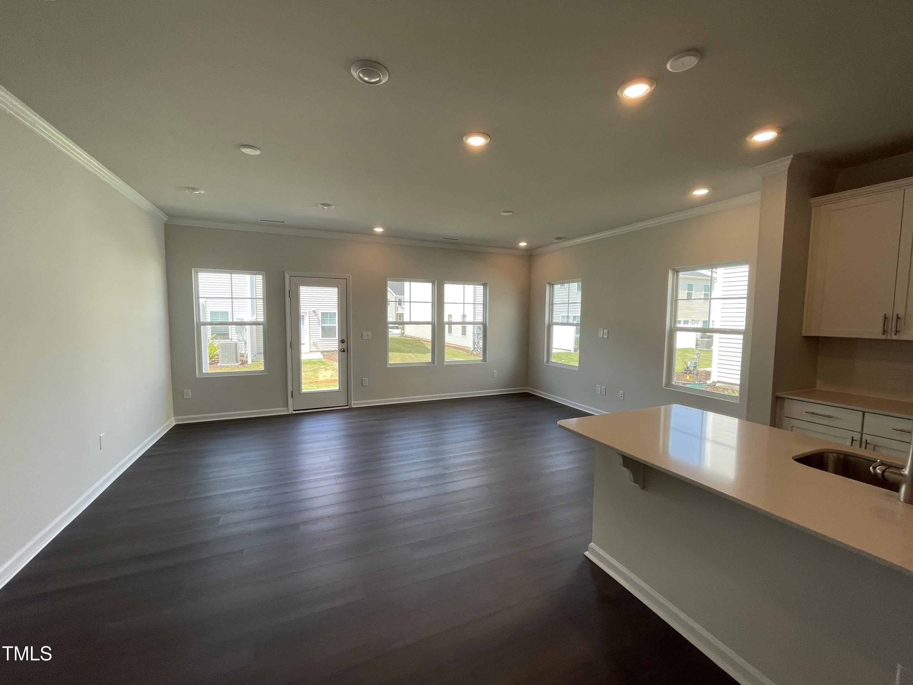 239 Paramount Drive Smithfield, NC 27577 - Photo 4 of 16 a view of an empty room with window and wooden floor