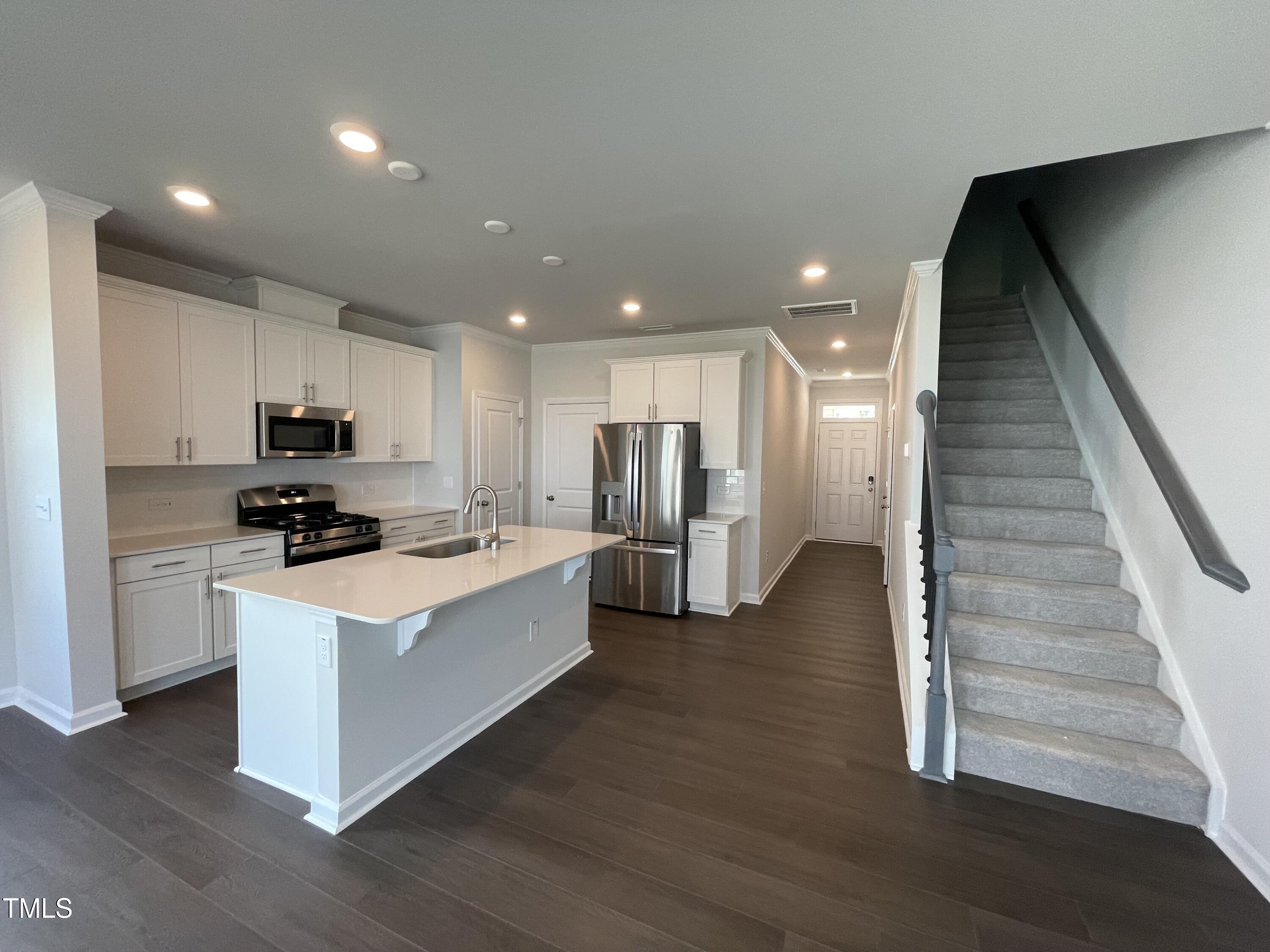 239 Paramount Drive Smithfield, NC 27577 - Photo 6 of 16 a kitchen with a refrigerator and a stove top oven
