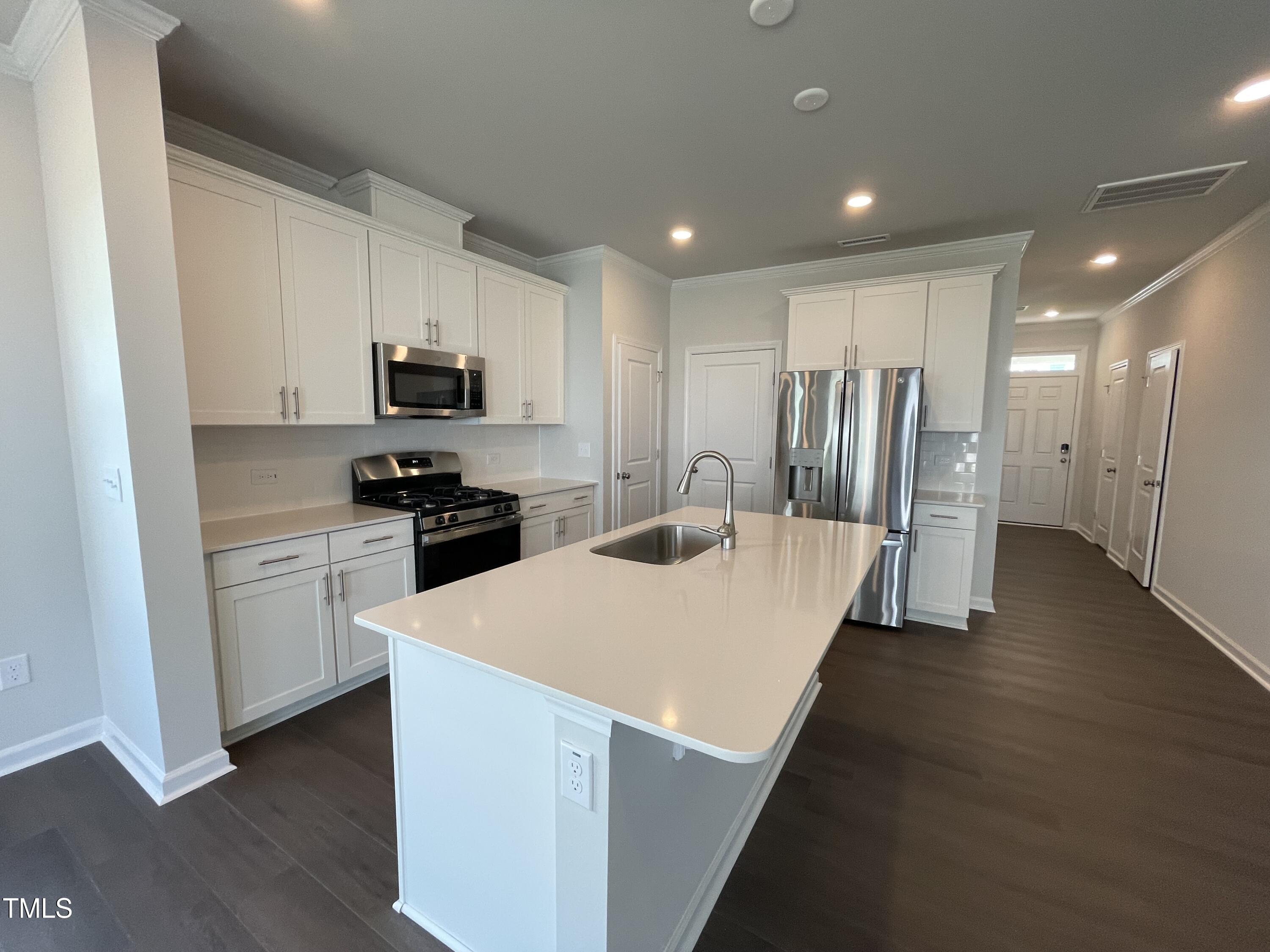 239 Paramount Drive Smithfield, NC 27577 - Photo 7 of 16 a kitchen with stainless steel appliances a refrigerator stove microwave and cabinets