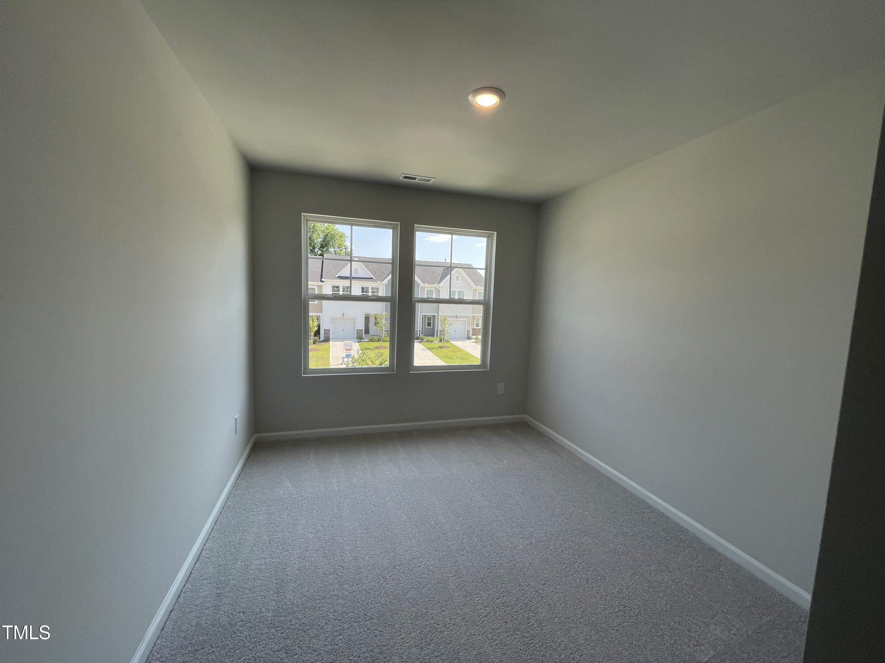 239 Paramount Drive Smithfield, NC 27577 - Photo 9 of 16 an empty room with windows