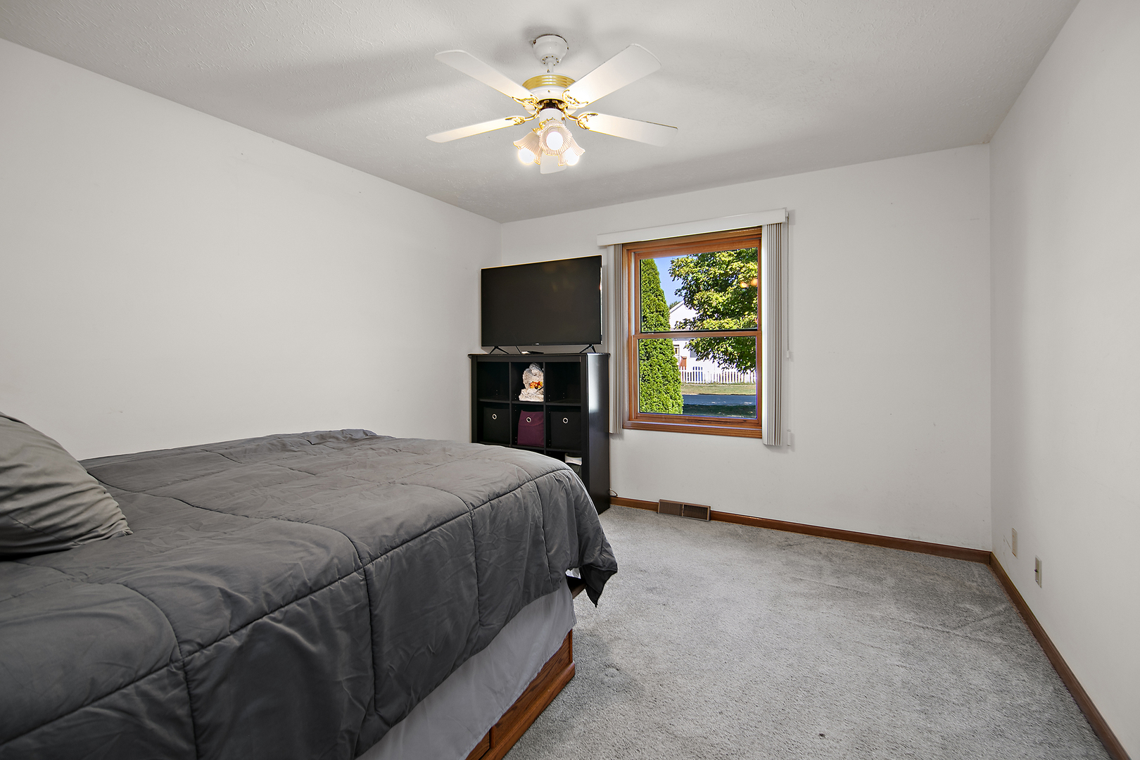 126 East Cleveland Street Cullom, IL 60929 - Photo 14 of 29 a bedroom with a bed and a chandelier