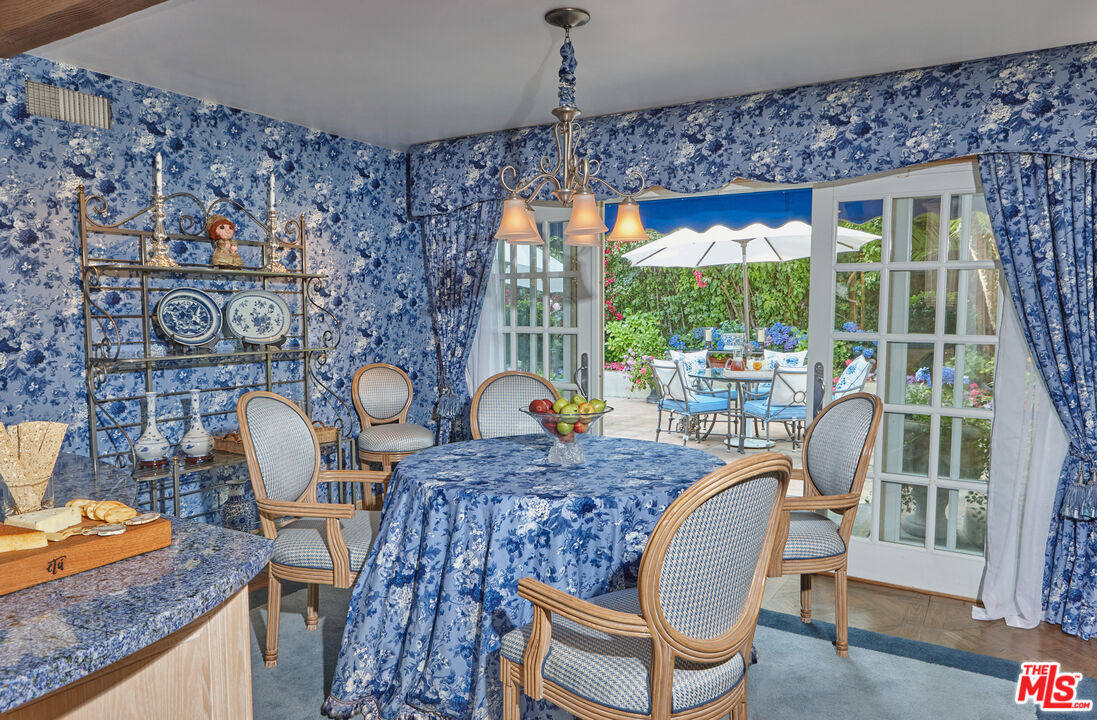 10957 Bellagio Road Los Angeles, CA 90077 - Photo 12 of 18 a dining room with furniture a rug and wooden floor