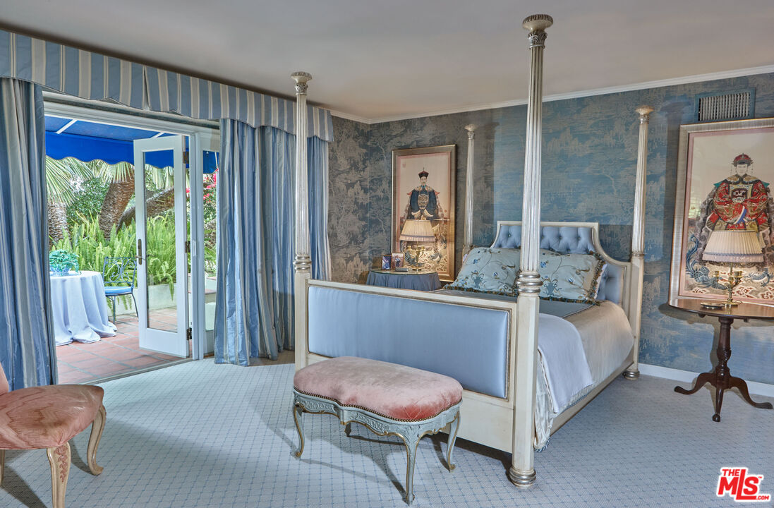 10957 Bellagio Road Los Angeles, CA 90077 - Photo 14 of 18 a bedroom with a bed window and a chair