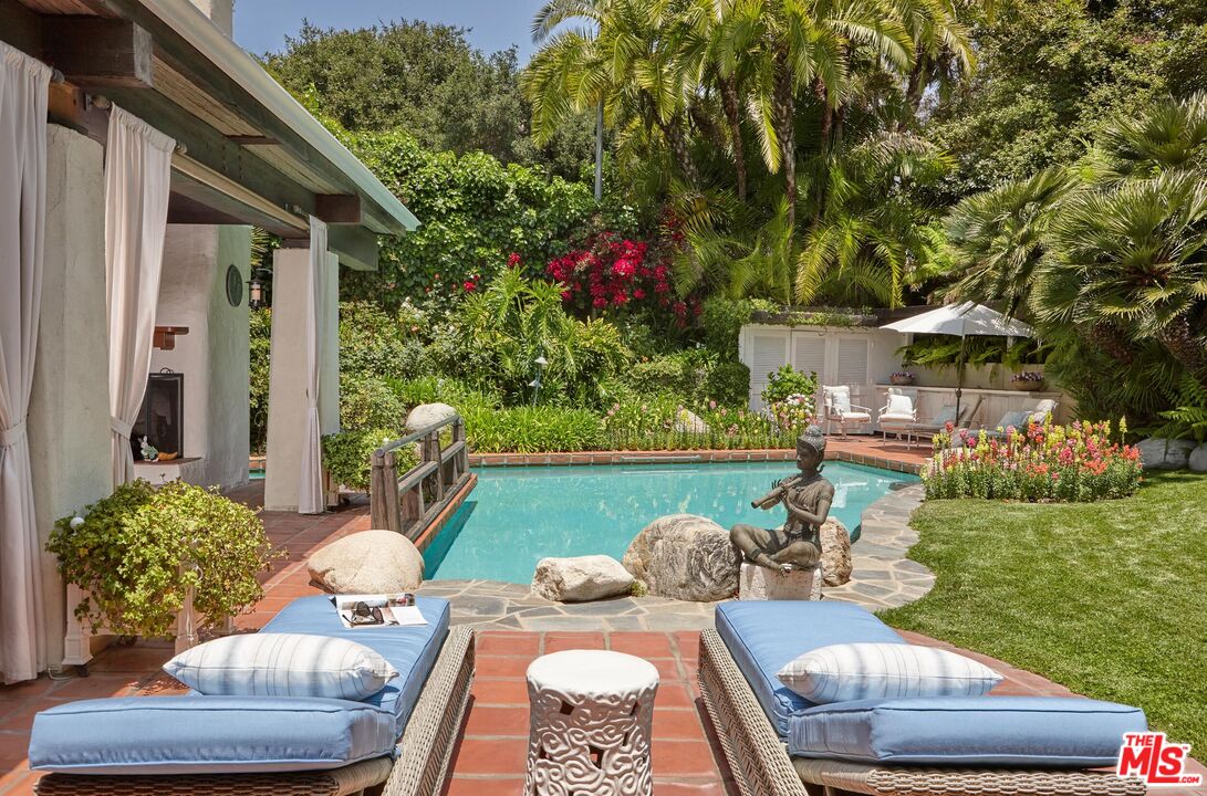 10957 Bellagio Road Los Angeles, CA 90077 - Photo 16 of 18 a view of a patio with couches table and chairs and potted plants