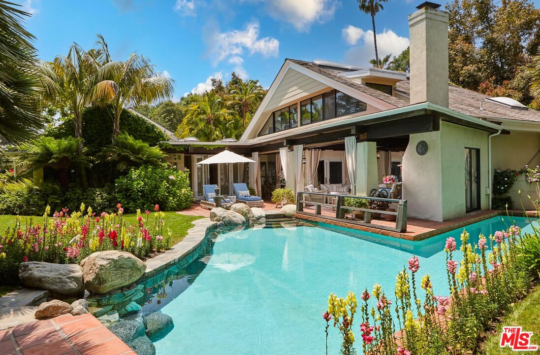 10957 Bellagio Road Los Angeles, CA 90077 - Photo 4 of 18 a front view of a house with swimming pool garden and patio
