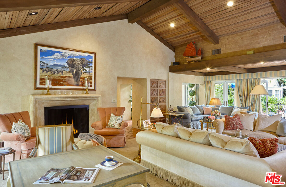 10957 Bellagio Road Los Angeles, CA 90077 - Photo 7 of 18 a living room with furniture and a fireplace