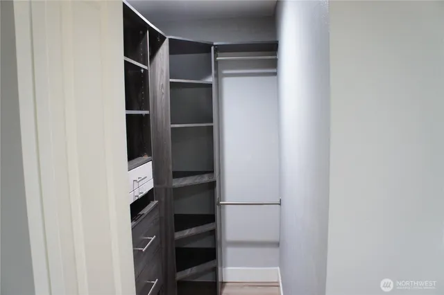 a view of walk in closet with clothes