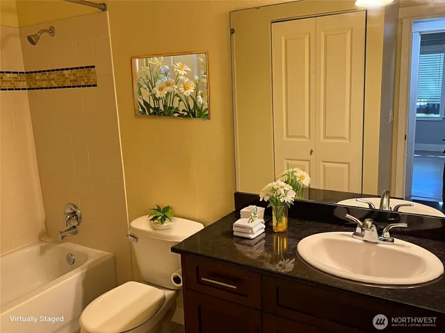 a bathroom with a double vanity sink and a mirror
